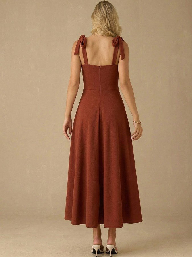 Back view of the rust sweetheart tie-strap midi dress, showing its silhouette and design details.