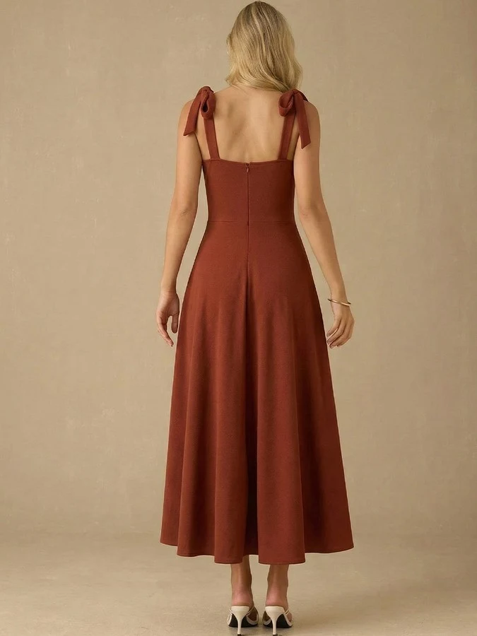 Back view of the rust sweetheart tie-strap midi dress, showing its silhouette and design details.