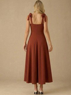 Back view of the rust sweetheart tie-strap midi dress, showing its silhouette and design details.