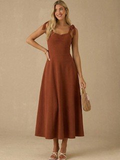 Front view of the rust sweetheart tie-strap midi dress, showing its silhouette and design details.