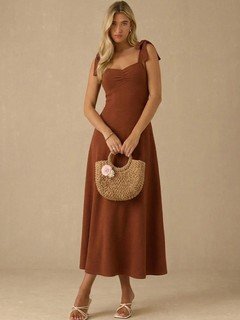 Styled front view of the rust sweetheart tie-strap midi dress, showing its silhouette and design details.