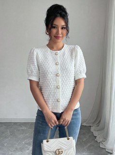 Full length front view of the white textured button-front short-sleeve blouse, showing the silhouette and fit.