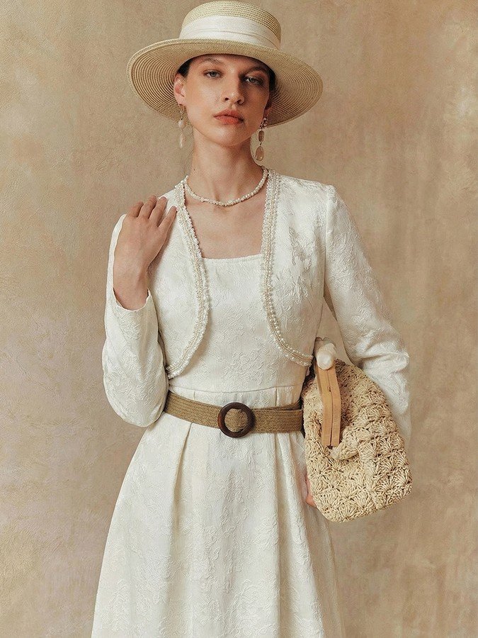Front view of the cream textured jacket and dress set, showing its silhouette and design details.