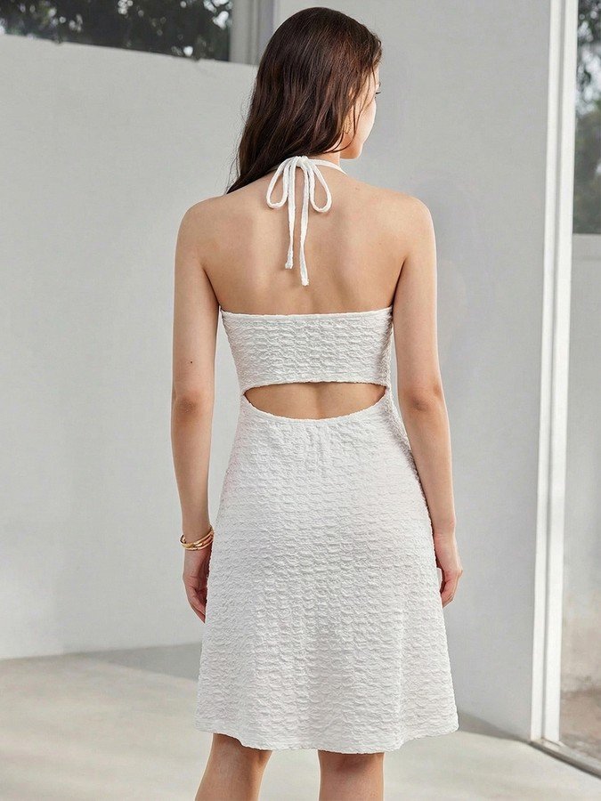 Back view of the white starfish halter cutout dress, showing its silhouette and design details.
