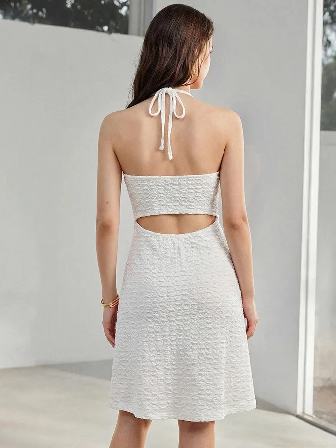 Back view of the white starfish halter cutout dress, showing its silhouette and design details.