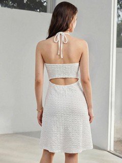 Back view of the white starfish halter cutout dress, showing its silhouette and design details.