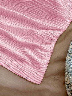 Fabric detail of the pink textured tie-halter tank top, showing the surface texture and finish.