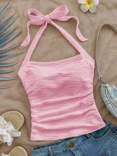 Flat-lay view of the pink textured tie-halter tank top, showing the garment shape and finish.