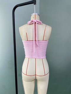 Mannequin view of the pink textured tie-halter tank top, showing the garment shape and construction.