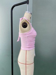 Mannequin view of the pink textured tie-halter tank top, showing the garment shape and construction.