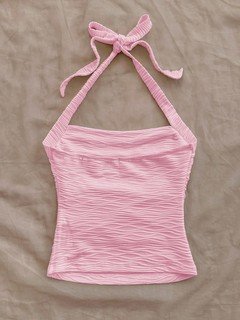 Flat-lay view of the pink textured tie-halter tank top, showing the garment shape and finish.