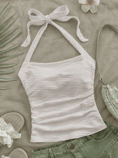 Flat-lay view of the white textured tie-halter tank top, showing the garment shape and finish.