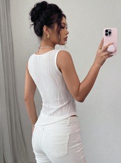 Angled back view of the white textured v-neck ruched sleeveless tank top, showing the silhouette and fit.