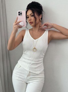 Angled front view of the white textured v-neck ruched sleeveless tank top, showing the silhouette and fit.