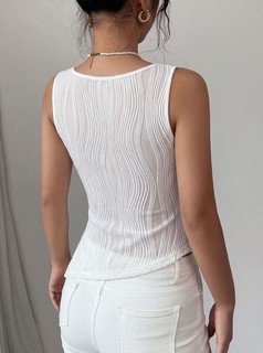 Back view of the white textured v-neck ruched sleeveless tank top, showing the silhouette and fit.