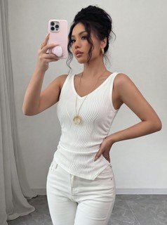 Side view of the white textured v-neck ruched sleeveless tank top, showing the silhouette and fit.