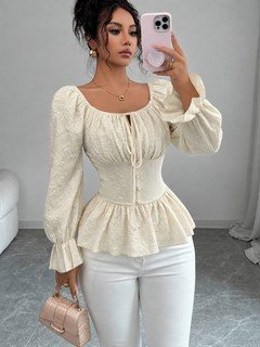 Full-length front view of the cream tie-neck corset peplum blouse, showing its silhouette and design details.