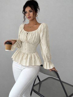 Styled front view of the cream tie-neck corset peplum blouse, showing its silhouette and design details.
