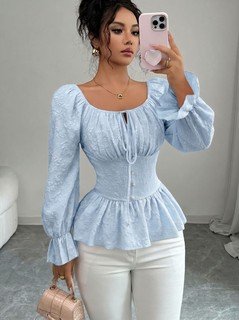 Angled front view of the light blue tie-neck corset peplum blouse, showing its silhouette and design details.