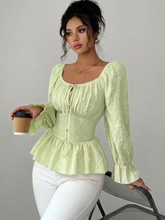 Full-length front view of the light green tie-neck corset peplum blouse, showing its silhouette and design details.