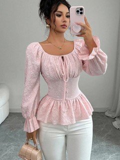 Angled front view of the pink tie-neck corset peplum blouse, showing its silhouette and design details.