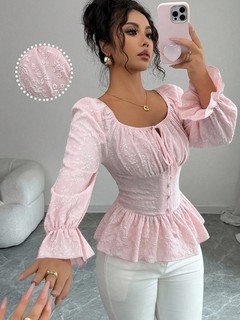 Styled front view of the pink tie-neck corset peplum blouse, showing its silhouette and design details.