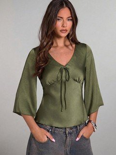 Angled front view of the olive green ruched tie-front bell-sleeve top, showing its silhouette and design details.