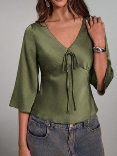 Full-length front view of the olive green ruched tie-front bell-sleeve top, showing its silhouette and design details.