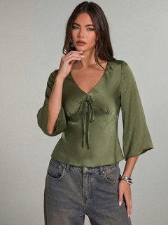 Styled front view of the olive green ruched tie-front bell-sleeve top, showing its silhouette and design details.