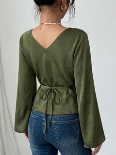 Back view of the olive v-neck bell-sleeve tie-waist blouse, showing the silhouette and fit.