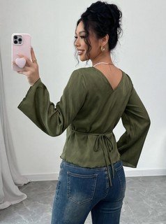 Front close up of the olive v-neck bell-sleeve tie-waist blouse, showing v-neckline, bell sleeves and adjustable tie waist.