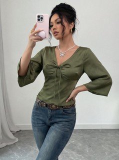 Side view of the olive v-neck bell-sleeve tie-waist blouse, showing the silhouette and fit.