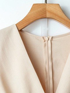 Back zip detail of the ivory v-neck belted long-sleeve wide-leg jumpsuit, showing v-neckline, long sleeves and contrast waist belt.