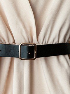 Belt detail of the ivory v-neck belted long-sleeve wide-leg jumpsuit, showing v-neckline, long sleeves and contrast waist belt.