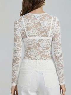 Back view of the white v-neck sheer floral lace top, showing its silhouette and design details.