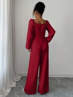 Back view of the red v-neck tie-waist long-sleeve wide-leg jumpsuit, showing the silhouette and fit.