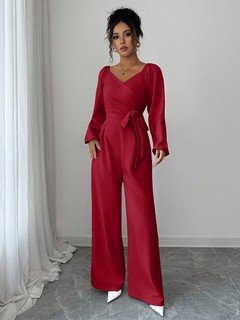 Full length front view of the red v-neck tie-waist long-sleeve wide-leg jumpsuit, showing the silhouette and fit.