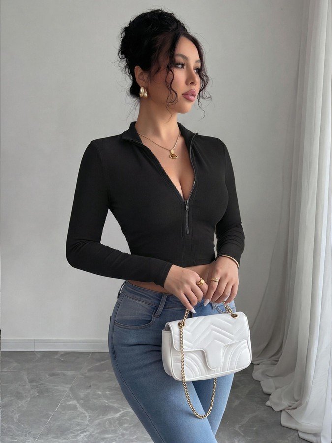 Angled front view of the black zip-front deep-v long-sleeve cropped top, showing the silhouette and fit.