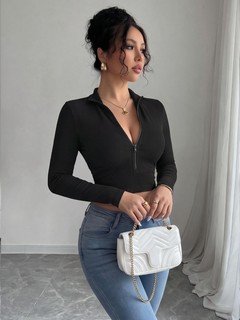 Angled front view of the black zip-front deep-v long-sleeve cropped top, showing the silhouette and fit.