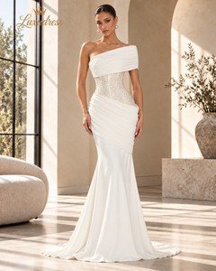 Front view of an ivory one shoulder mermaid gown with a beaded corset bodice, asymmetric draping and a fitted silhouette.