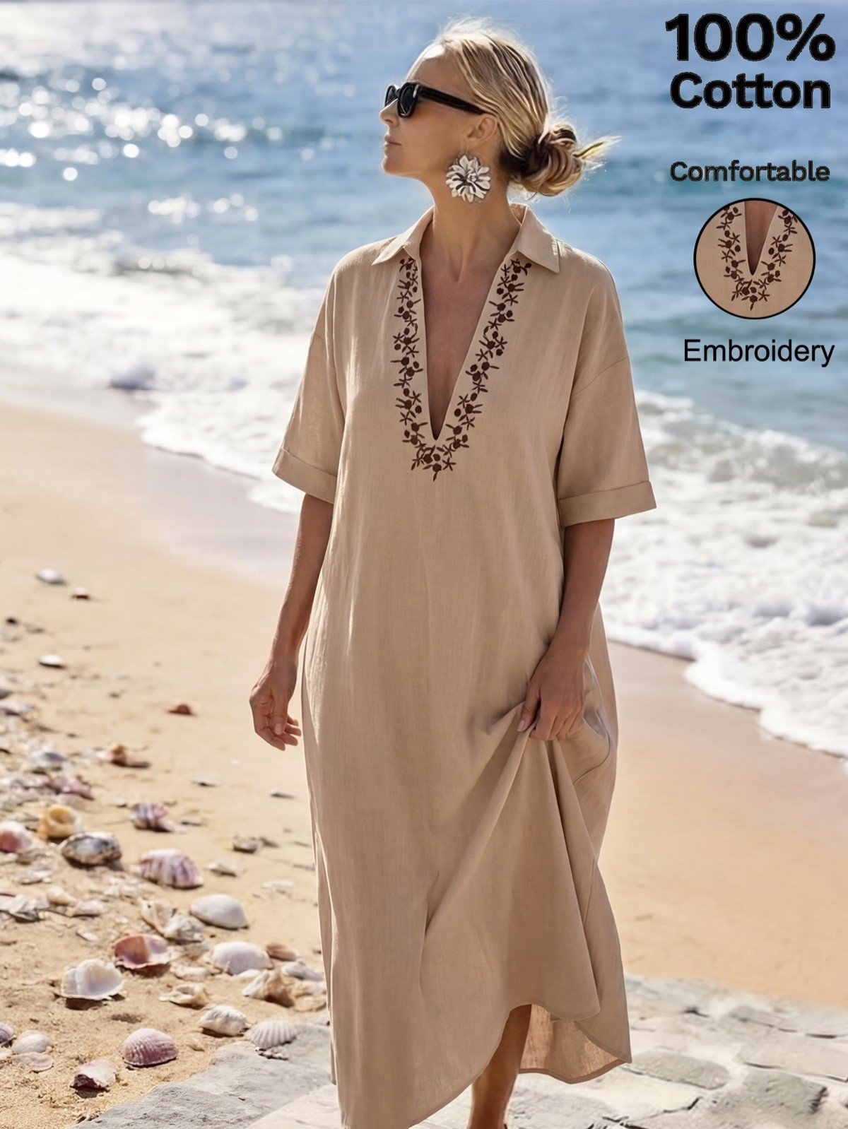 Beach front view of a beige cotton kaftan maxi dress with V-neck embroidery.