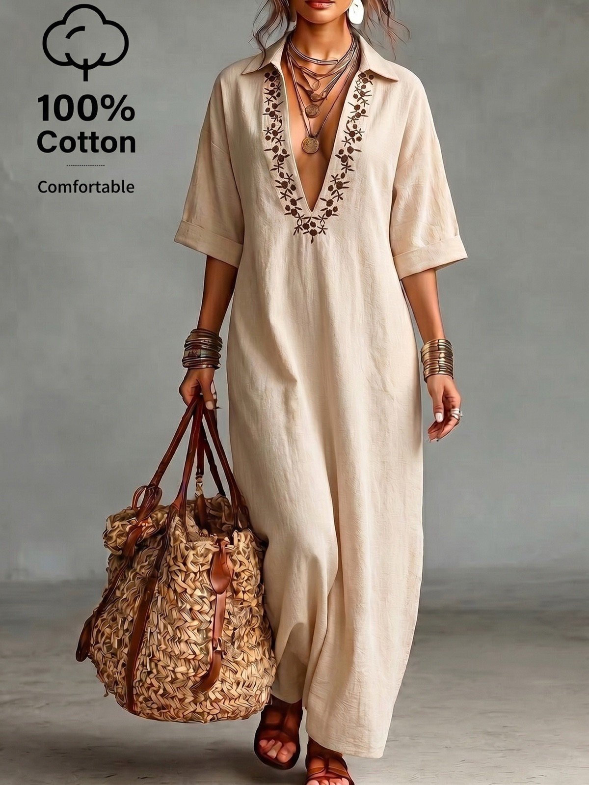 Studio front view of a beige cotton kaftan maxi dress with V-neck embroidery.
