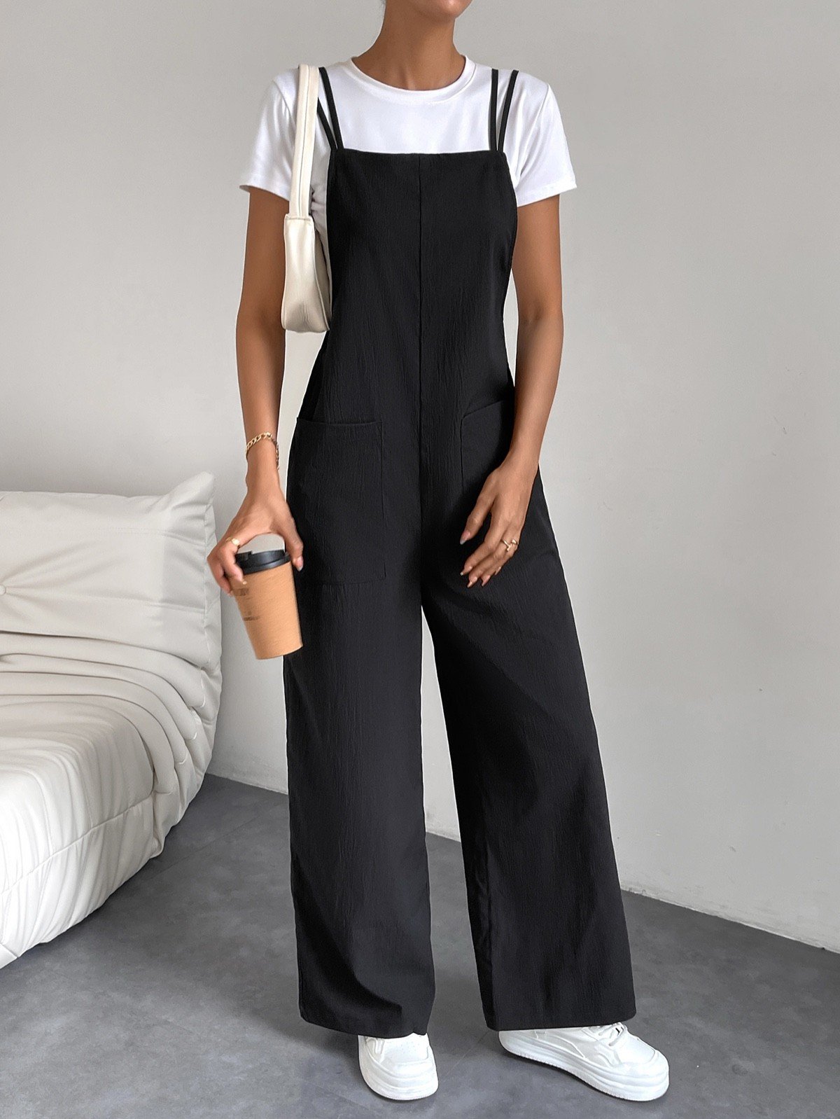 Cotton Wide-Leg Overall Jumpsuit – Primary Front View Primary front view of a black cotton wide-leg bib overall jumpsuit with patch pockets.