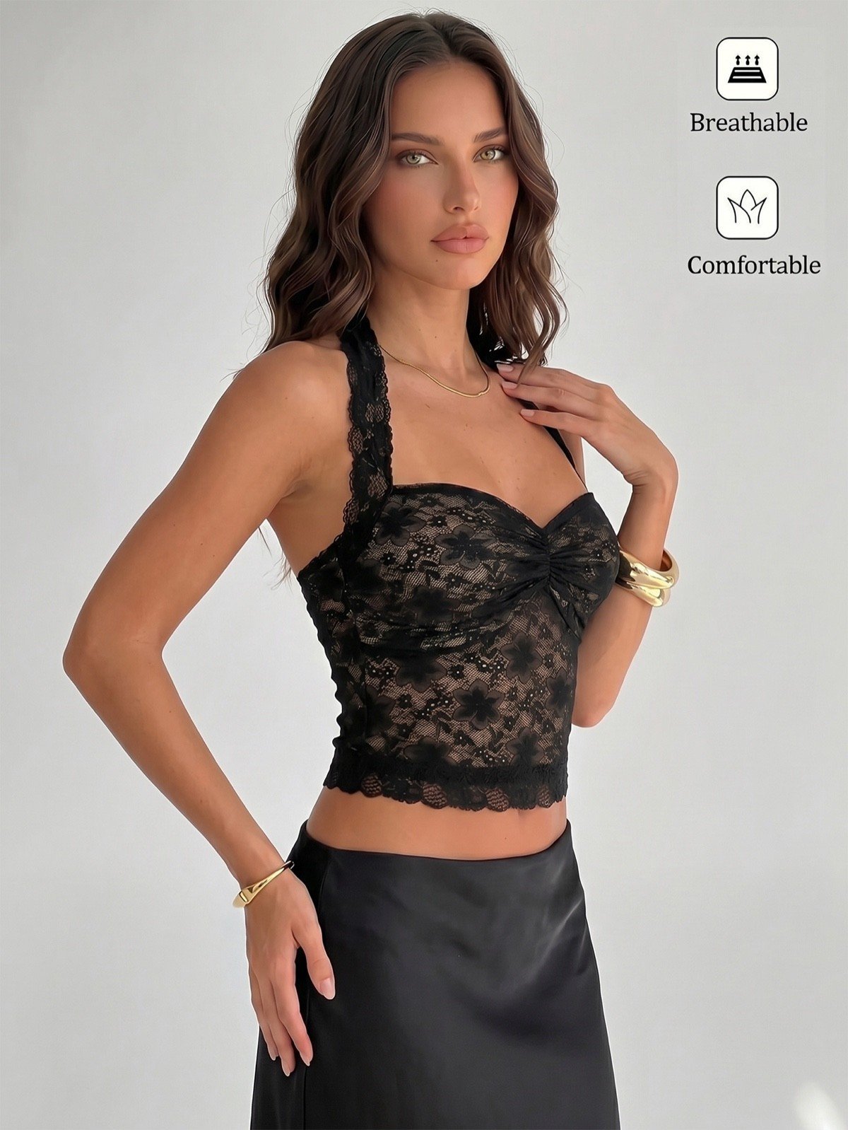 Angled front view of a black floral lace halter corset crop top with cross-back straps.