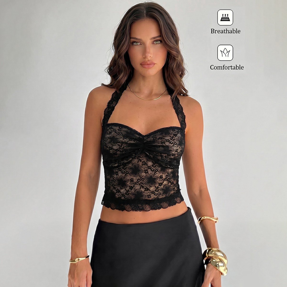 Front fit and fabric detail of a black floral lace halter corset crop top with cross-back straps.