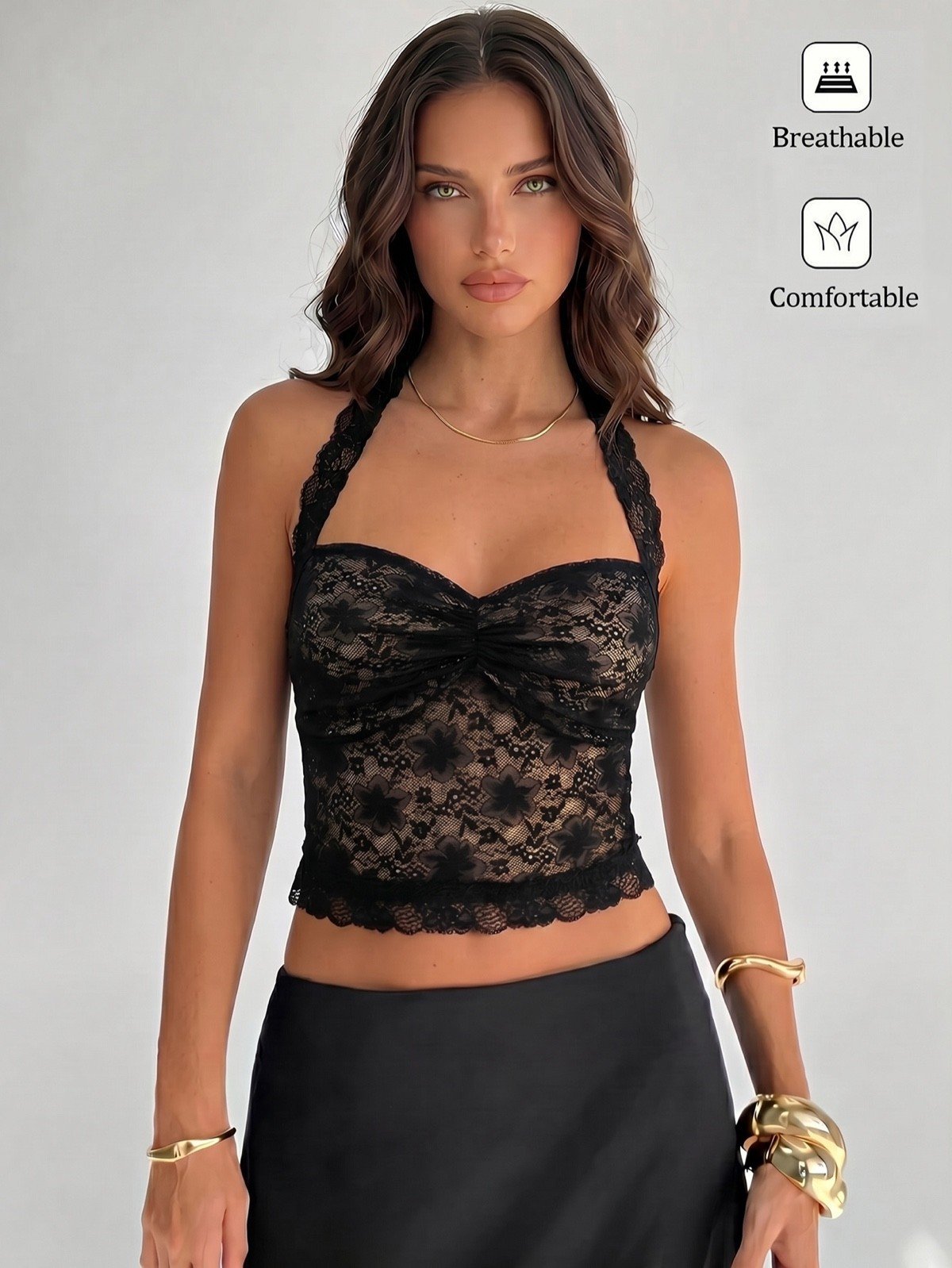 Front styling view of a black floral lace halter corset crop top with cross-back straps.