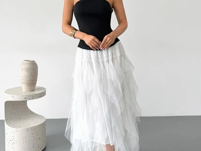 A corset-bodice tulle midi dress photographed at an angle