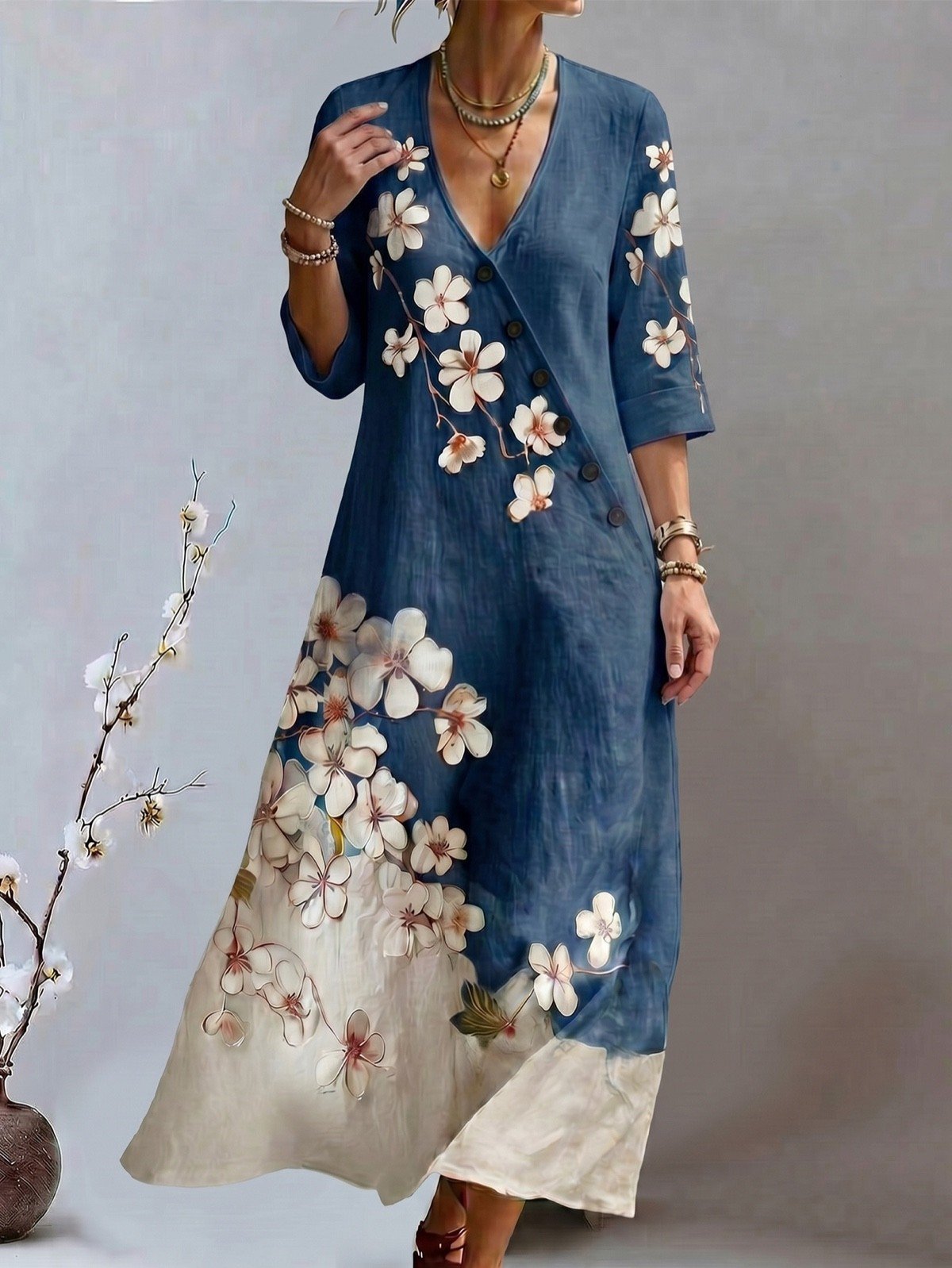 Model front view of a blue floral print V-neck maxi dress with three-quarter sleeves.