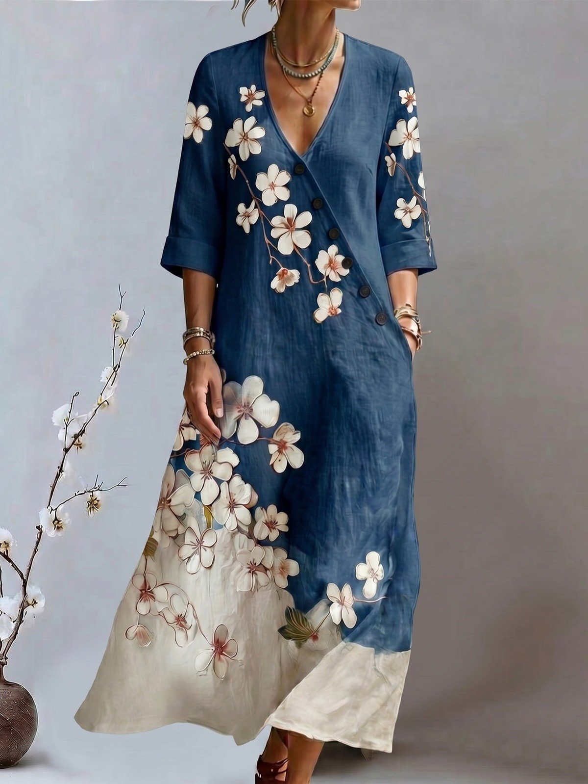 Relaxed front view of a blue floral print V-neck maxi dress with three-quarter sleeves.