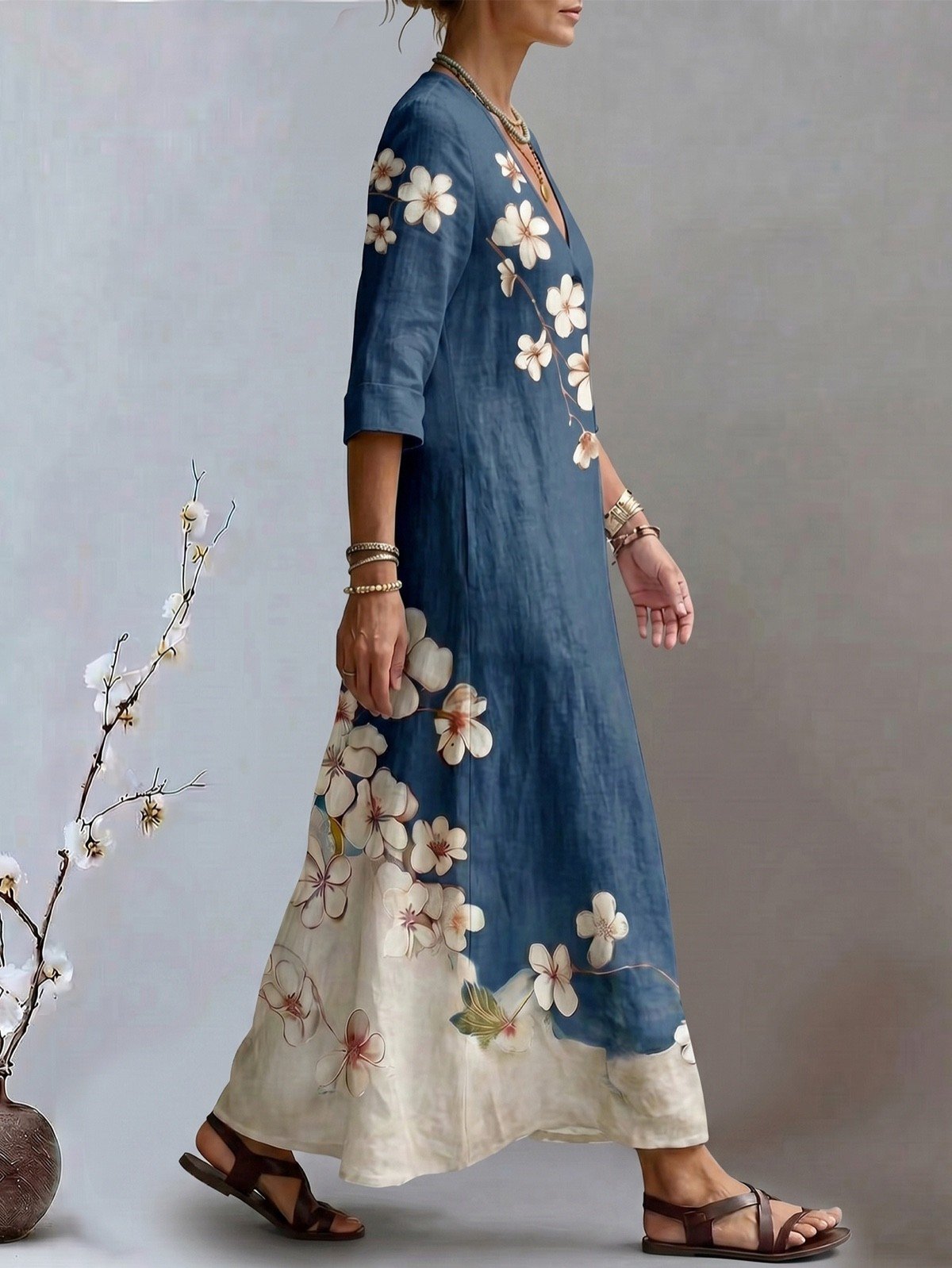 Side view of a blue floral print V-neck maxi dress with three-quarter sleeves.